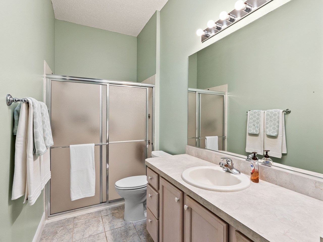 primary bathroom walk in shower anchors the long bath. lots of counter space plus a large linen closet.