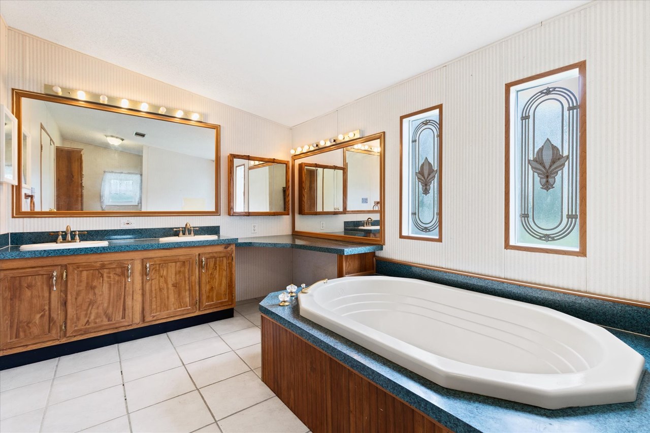 huge primary bath the en suite bath boasts large soaking tub, dual sinks and separate water closet with walk-in shower.