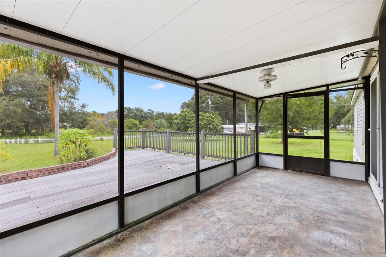 screen porch rear covered screen porch opens to the large deck overlooking the back yard and acreage.