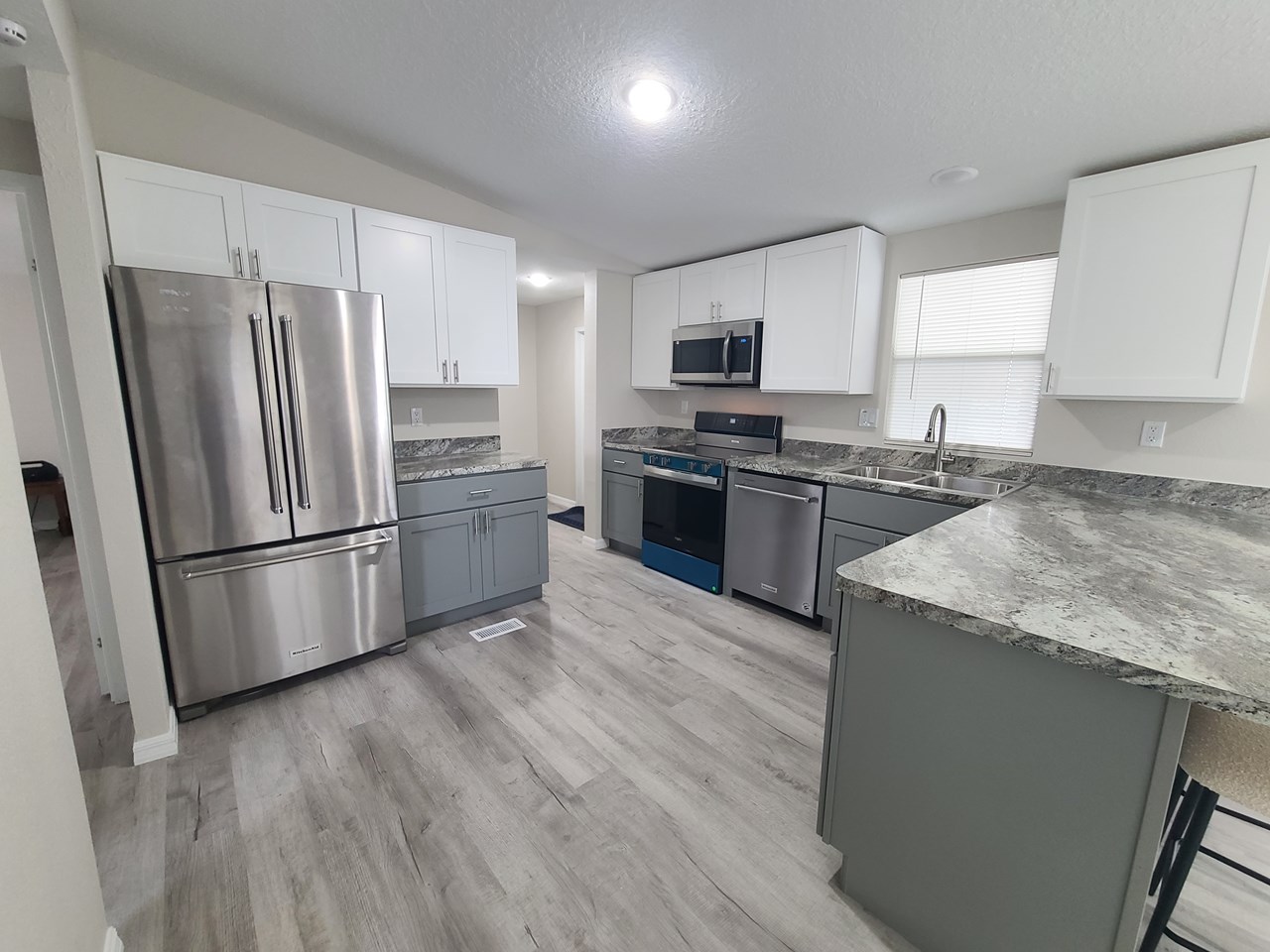 new kitchen brand new kitchen with new stainless steel appliances, laundry room and exit through the doorway.