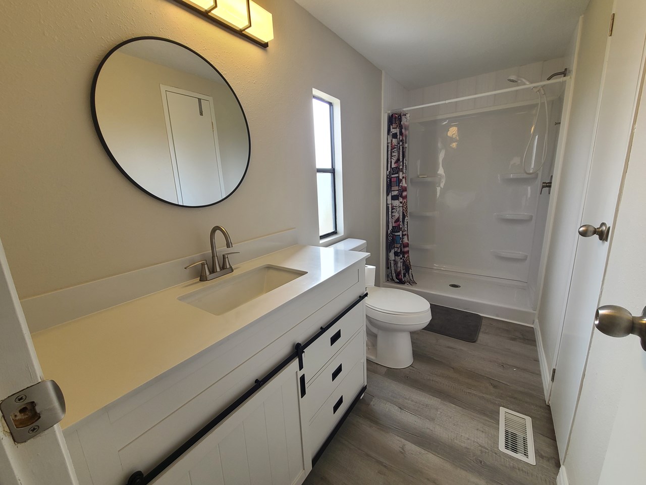 primary bath brand new bath with walk-in shower, linen closed and new vanity.